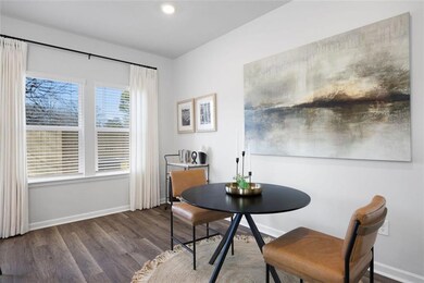 Dining area with baseboards and wood finished floo