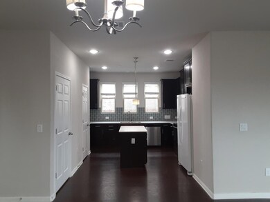 Kitchen featuring hanging light fixtures, tastefu