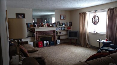Spacious living room with hardwood floors under th