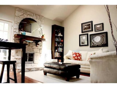 Living area with vaulted ceiling, a fireplace, an