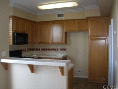 Kitchen with tile counters, black appliances, nice