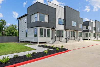 Side view of the 32 unit  complex with gated access and clean landscaping.