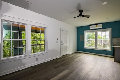Foyer featuring an AC wall unit, wood finished floors, ceiling fan, and recessed lighting