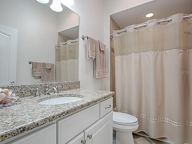 GUEST BATH WITH GRANITE COUNTER, TILE FLOORING, TI