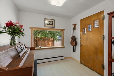 Foyer featuring baseboards, baseboard heating, and