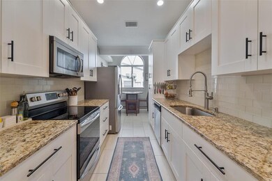 Eat in Kitchen with Granite Counters and White shaker Cabinets