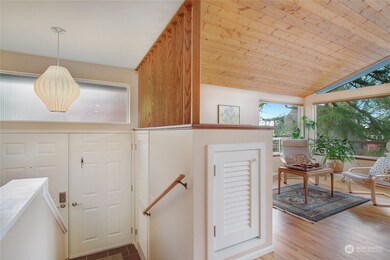 Formal entry with coat closet. Built-in storage at top of stairs.