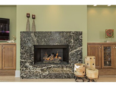 The marble fireplace surround is flanked by built-