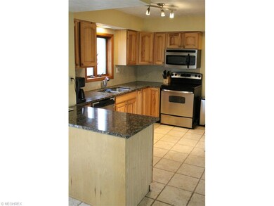 Kitchen boasts stainless, granite & ceramic floors