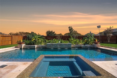 Luxurious custom pool and spa with an elegant fountain wall.