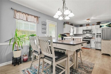 Dining room with light wood finished floors and a chandelier