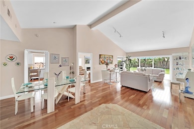 Entry View with Soaring Ceilings of Dinning Area and Living Room.