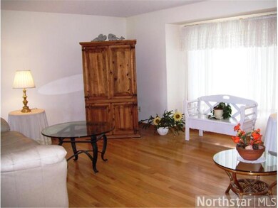 View of the living room with boxed out window to t