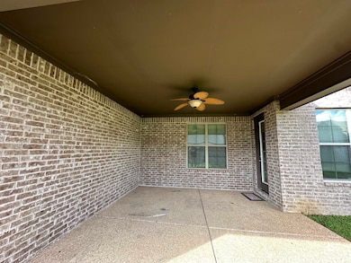 View of patio featuring a ceiling fan