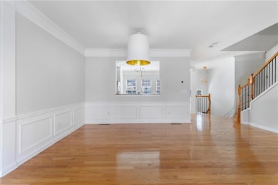 Unfurnished dining area featuring stairway, light 