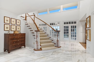 Marble floors frame curved staircase