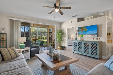 Living room with hardwood / wood-style flooring an