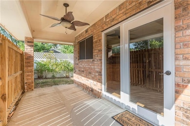 The covered patio opens to a side yard and is ready for your outdoor seating.