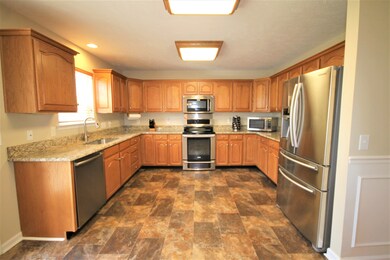 Large kitchen with granite counter tops and stainless steel appliances