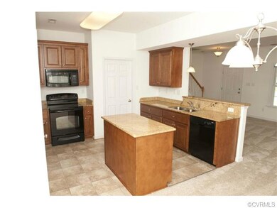 Black appliances including a smooth surface range,