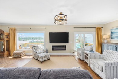 Living room featuring crown molding and hardwood / wood-style floors