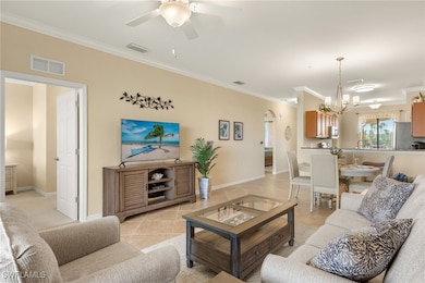 Living room with ornamental molding, arched walkwa