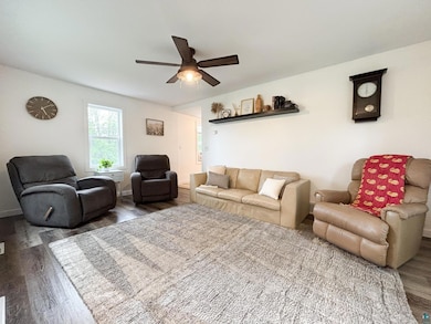 Living room featuring wood finished floors and ceiling fan