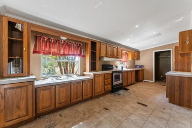 Kitchen featuring black electric range, sink, orna