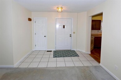 Entry foyer with ceramic flooring and guest closet