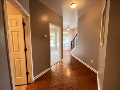 Hall featuring wood finished floors, baseboards, a