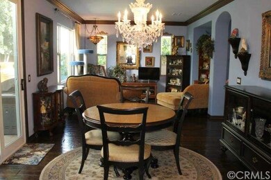Facing living room from dining area. Chandelier ex