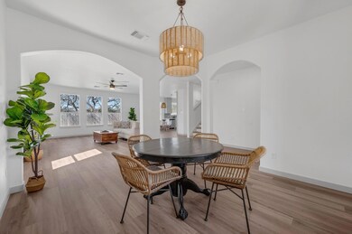 Dining room featuring visible vents, stairway, wo