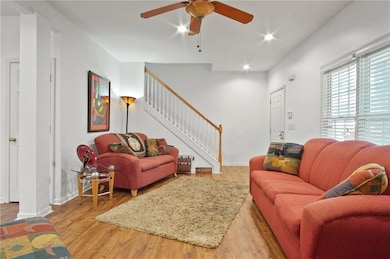 Living area with stairway, recessed lighting, base