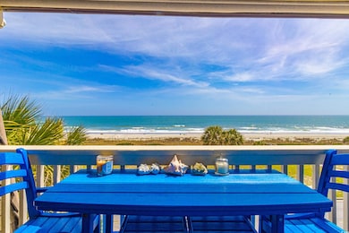 Balcony featuring a water view, a beach view, and outdoor dining space