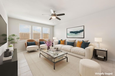 Living room featuring ceiling fan, baseboards, an