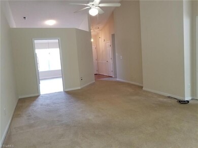 This view of the Great Room looking back toward the kitchen shows the volume ceiling and how the Great Room flows off of the kitchen area.  The master bedroom is off of this area and the 2nd bedroom is toward the front.
