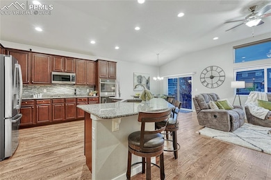 Kitchen with hardwood floors, looks out to dining and living room