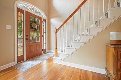 Entryway featuring baseboards and wood finished floors