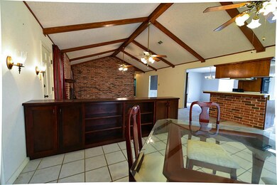 Breakfast area is separated from living area in this open floor plan by a built in cabinet