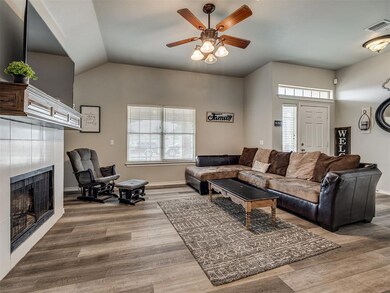 Living room with wood-type flooring, lofted ceilin