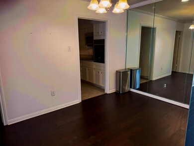 The photo shows the dining room with dark hardwood