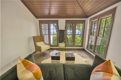 Sunroom / solarium with wooden ceiling, french doo