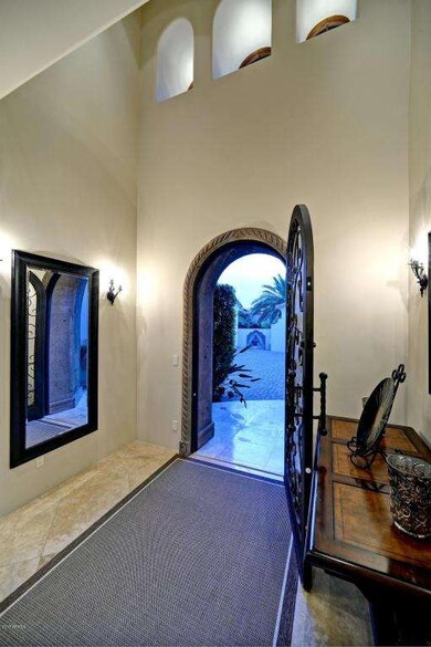 Foyer w/ wrought iron front entry door