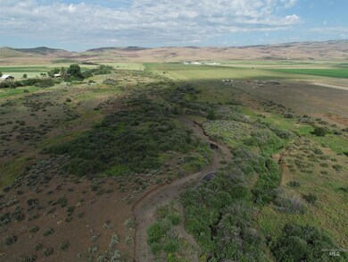 Aerial overview of property's location featuring a mountain backdrop and rural landscape
