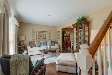 The formal living room is just to the left beyond the staircase.