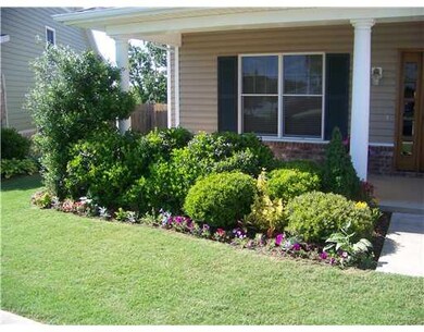 Land. The front is very inviting with this beautiful landscape bed