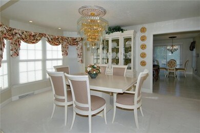 Dining Room - Elegant chandelier, wall-to-wall car