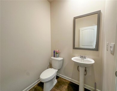 Bathroom with toilet and wood finished floors
