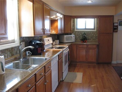 Large galley kitchen opens to dining room area.