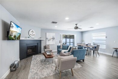Living room featuring ceiling fan and light hardwo
